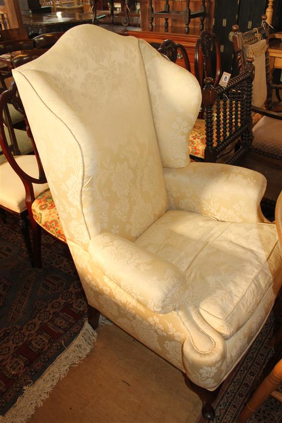 Georgian style wing chair covered in ivory brocade
